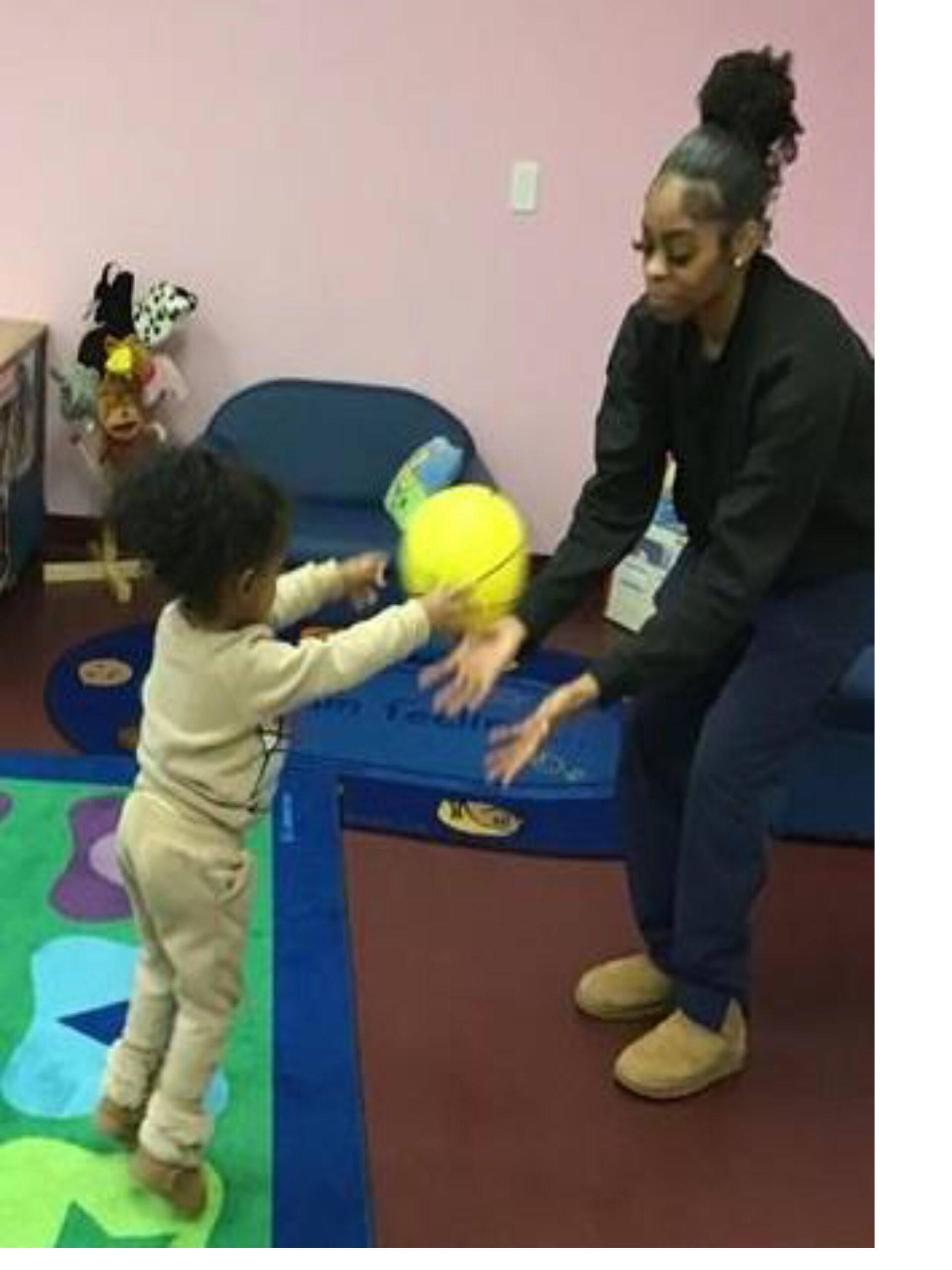 A young child and an adult share a playful moment