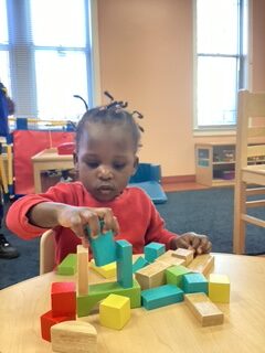 Child Playing with Blocks at Table